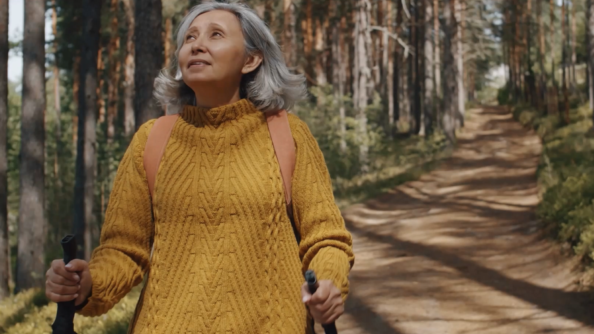 Older woman walking through forest setting