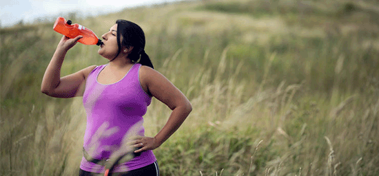 female patient drinking water during exercise